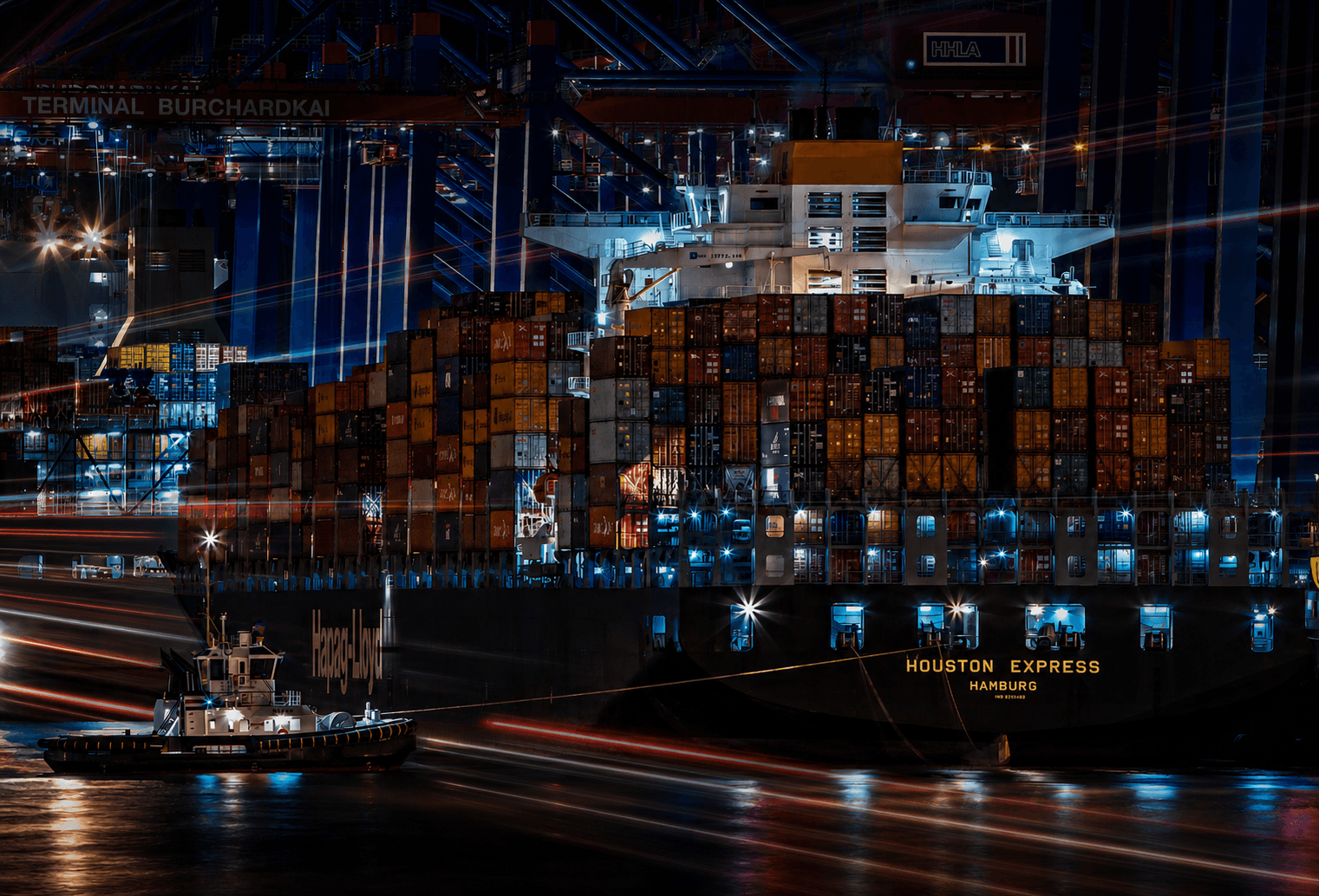 Stacked shipping containers in a port yard.